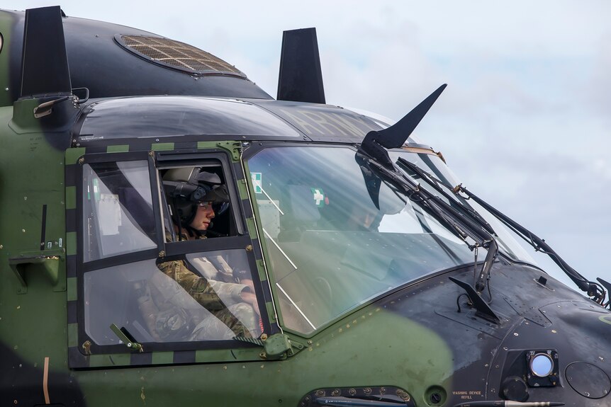 A pilot inside an army helicopter. 