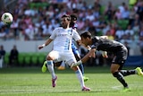 Melbourne City's David Villa (L) has his kick stolen by Newcastle's Mark Birighitti at AAMI Park.