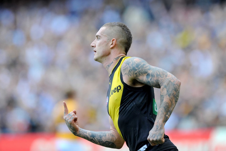 Dustin Martin of the Tigers reacts after kicking a goal against West Coast at the MCG in April 2017.