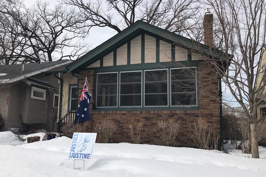 A Justice for Justine sign is seen out the front of Justine Damond Ruszczyk's house.