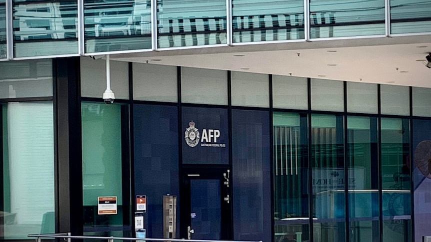 the exterior of an office building with Australian Federal Police above the door