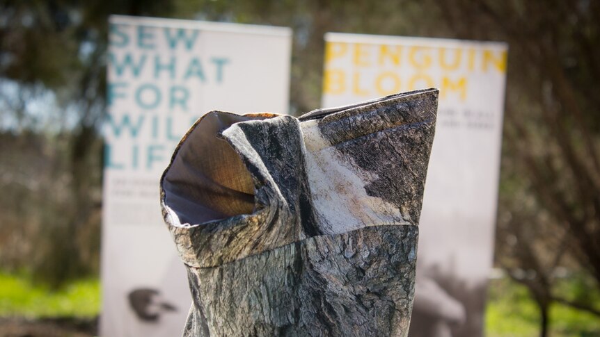 A sling for injured birds with the image of bark printed on its outside.