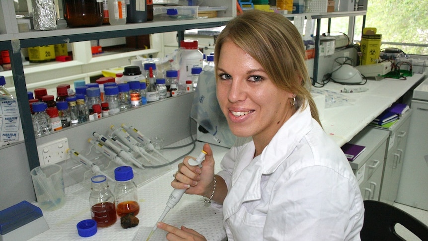 Karina Hamilton sits in a lab with some cerumen from Australian stingless bees.