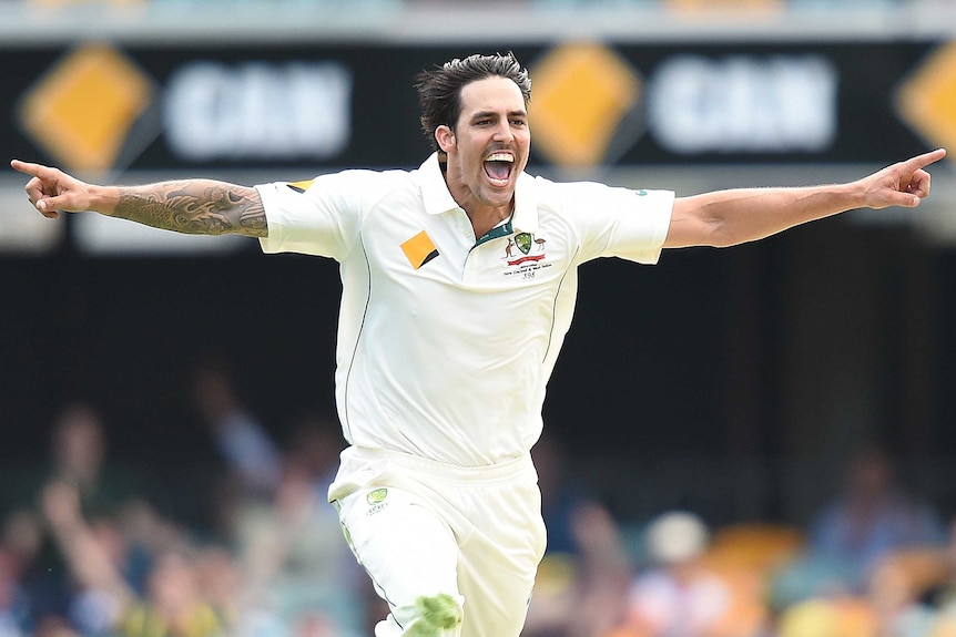 Mitchell Johnson celebrates a wicket with arms outstretched while playing for Australia's Test team.