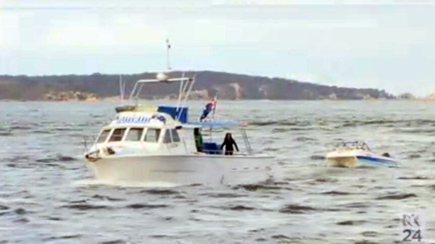 The catamaran is towed back to shore