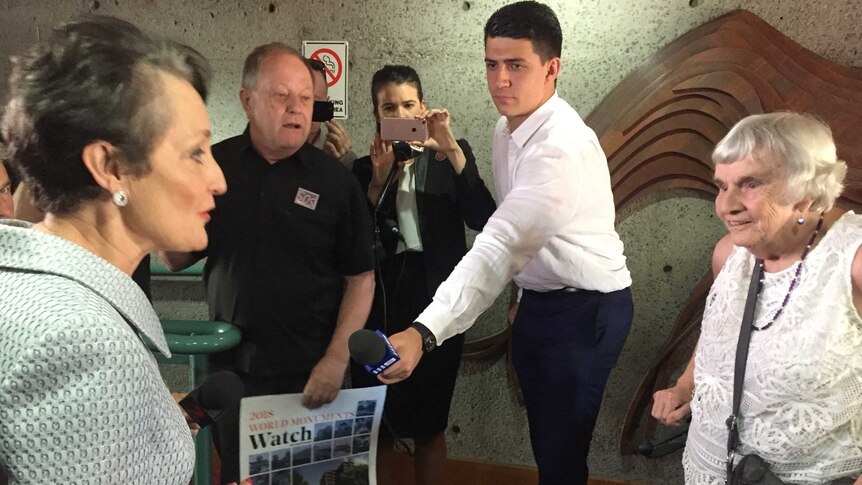 Community Services minister Pru Goward meets the last Sirius building resident Myra Demetriou with reporters in background.