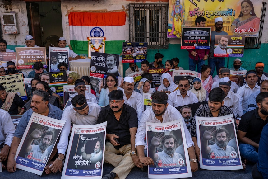 India's opposition Congress party activists hold placards during a silent protest.