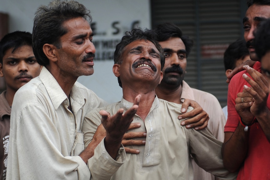 Man mourns after Pakistani factory fire