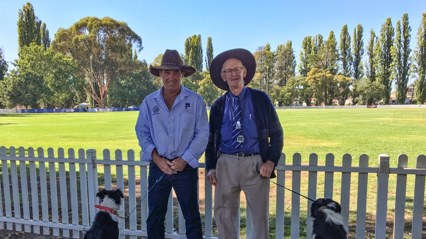 Mick Hudson and his father Pip standing with their two dogs at the showgrounds in Molong.