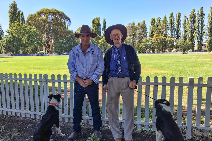 Mick Hudson and his father Pip standing with their two dogs at the showgrounds in Molong.