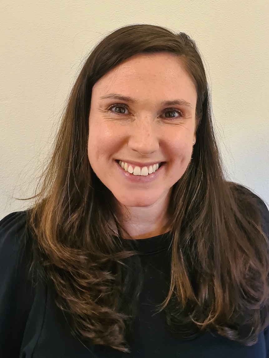 Woman with brown hair smiling.