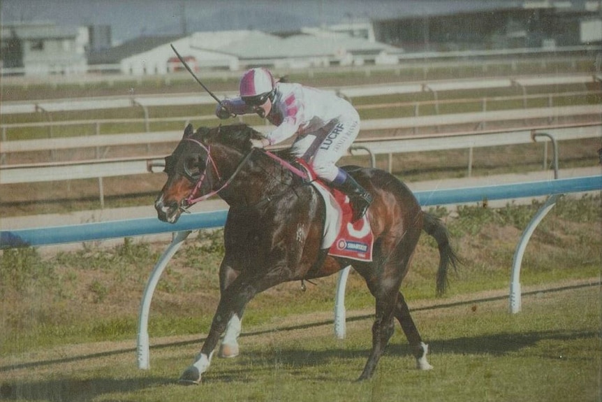 A female jockey racing a horse