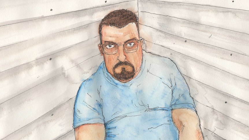 A man with a goatie wearing glasses in a blue T-shirt in a drawing