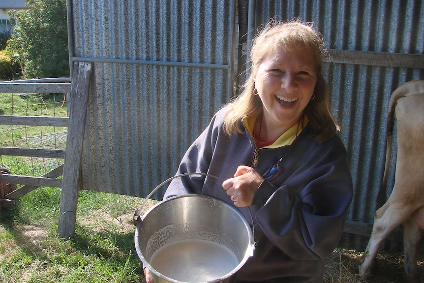 A cheesy grin from Lyndy Pinner, after a successful morning hand-milking her cow