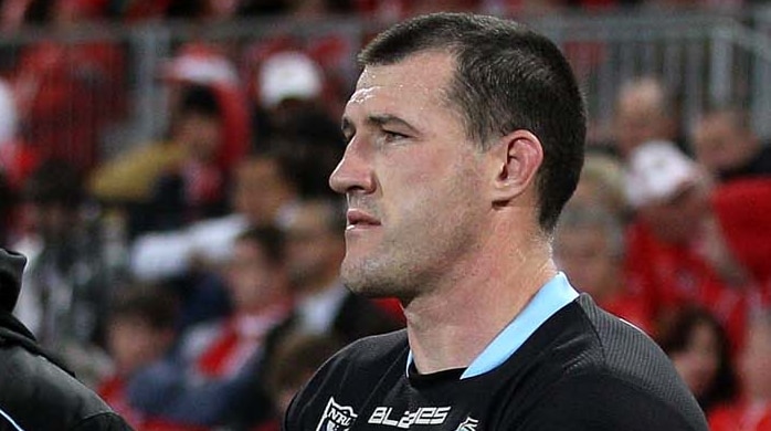 Paul Gallen sits on the bench with ice on his calf