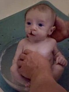Baby being bathed in a glass salad bowl
