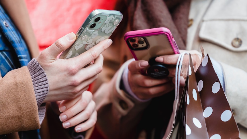 Two people with phones in their hands