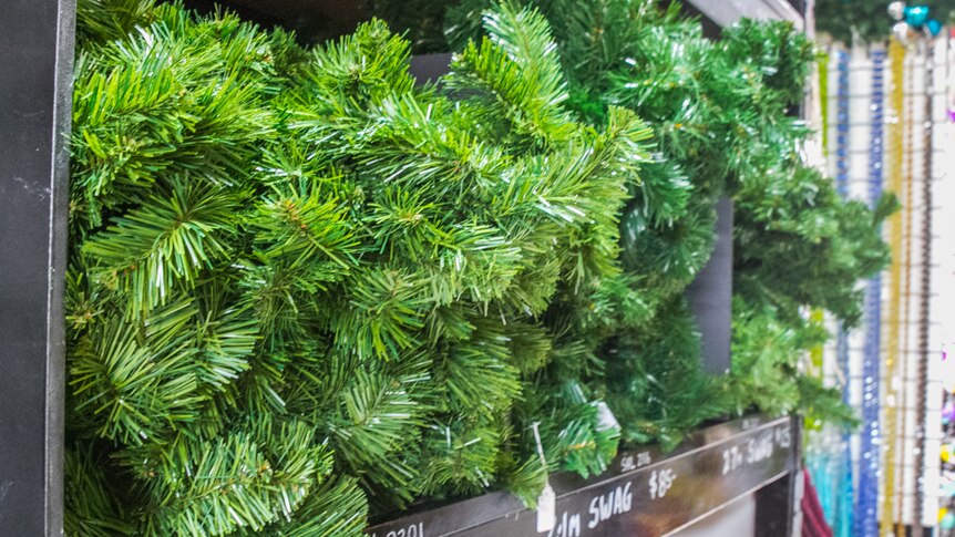 Individual Christmas tree branches are stacked in size and length in the prop showroom.