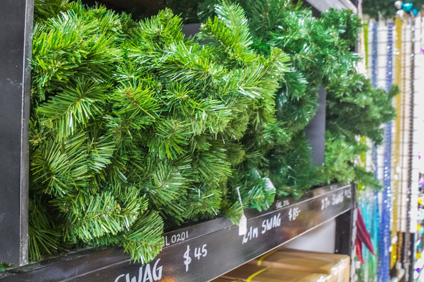 Individual Christmas tree branches are stacked in size and length in the prop showroom.