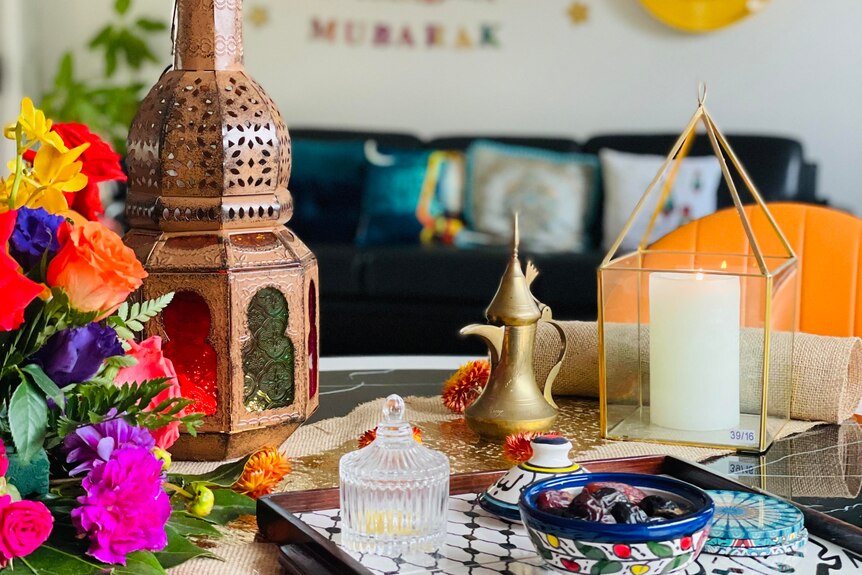 A photo of decorations Aseel uses to keep her home Ramadan theme, including a lamp, candles and flowers.