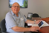 Roland Schultz holds an iPad