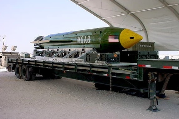 The 'mother of all bombs' is seen on a trailer at an air force base.