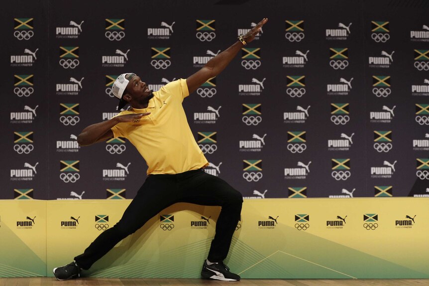 Usain Bolt poses at a press conference