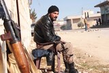 Syrian fighter guards against Islamic State of Iraq and the Levant
