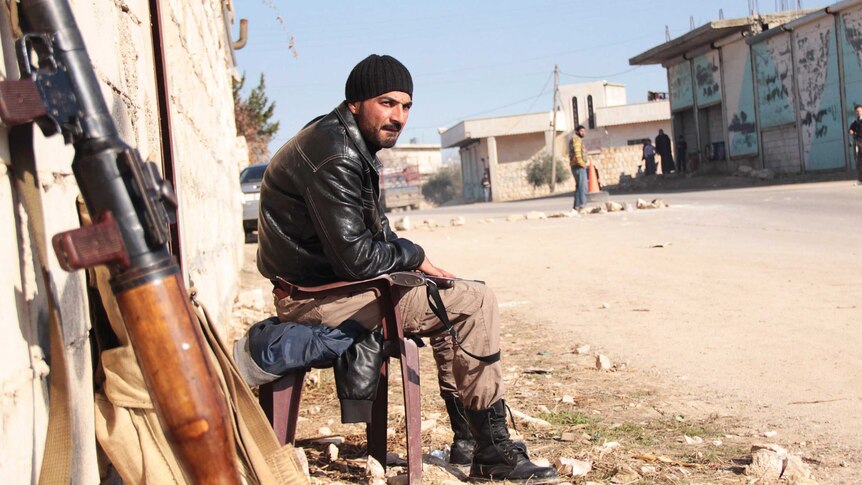 Syrian fighter guards against Islamic State of Iraq and the Levant