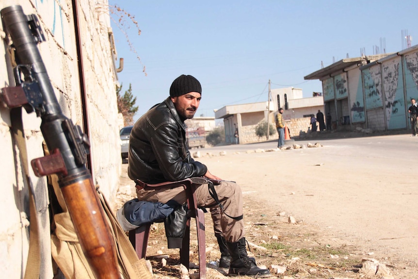 Syrian fighter guards against Islamic State of Iraq and the Levant