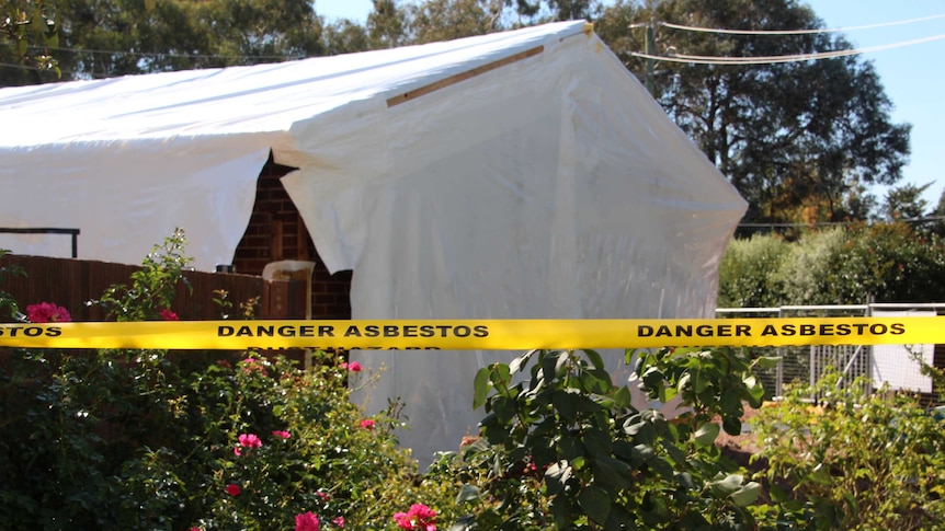A Kambah home containing asbestos wrapped in plastic in preparation for demolition.
