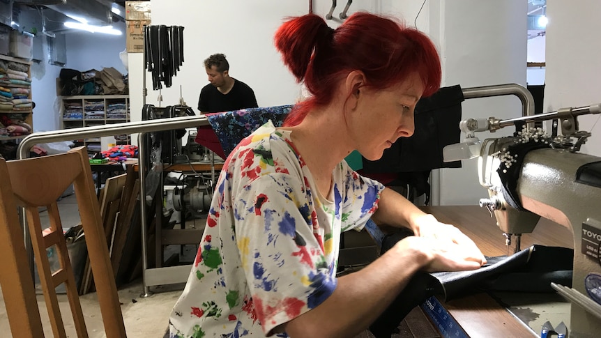 Christian Olea and Bex Frost at sewing machines in their workroom.