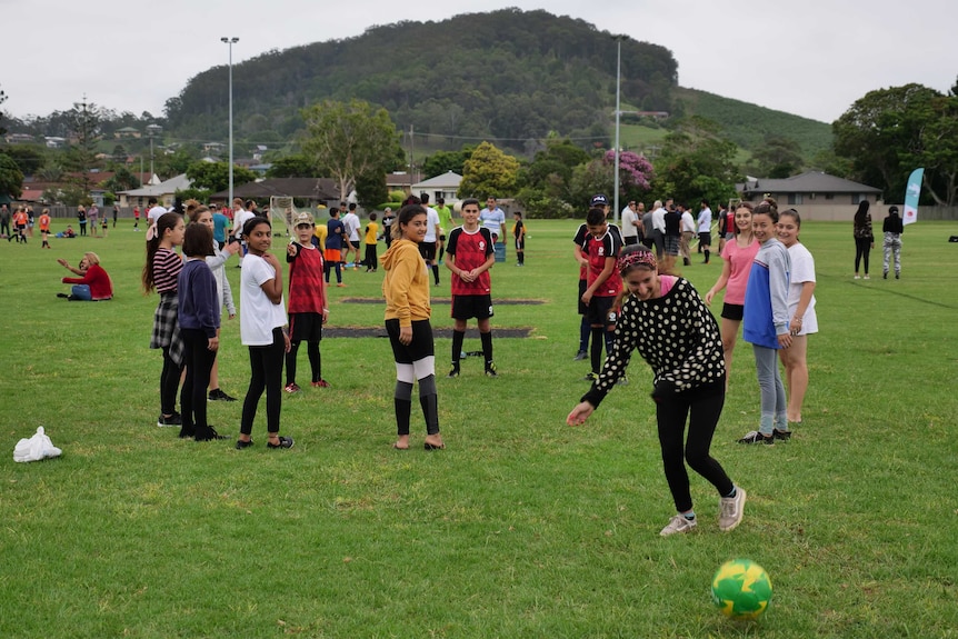 Girls kicking a soccer ball around