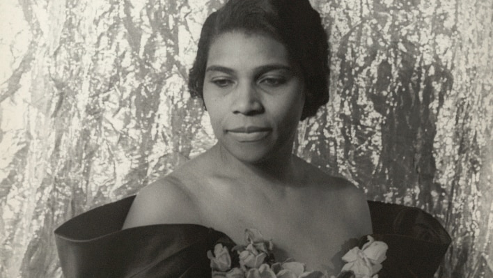 A black and white photograph of legendary contralto Marian Anderson in a gown.