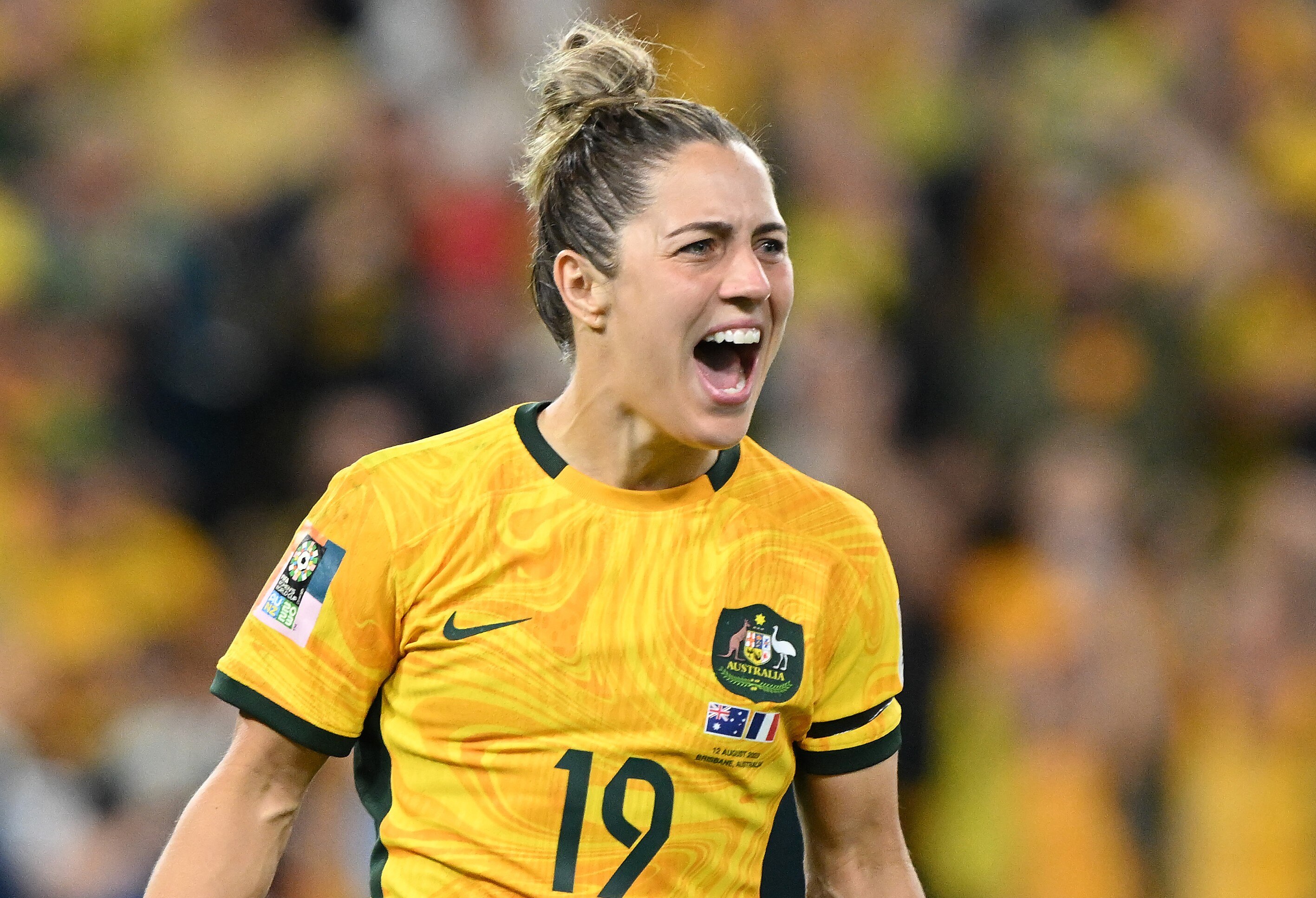 Katrina screams in delight as she celebrates on the field.