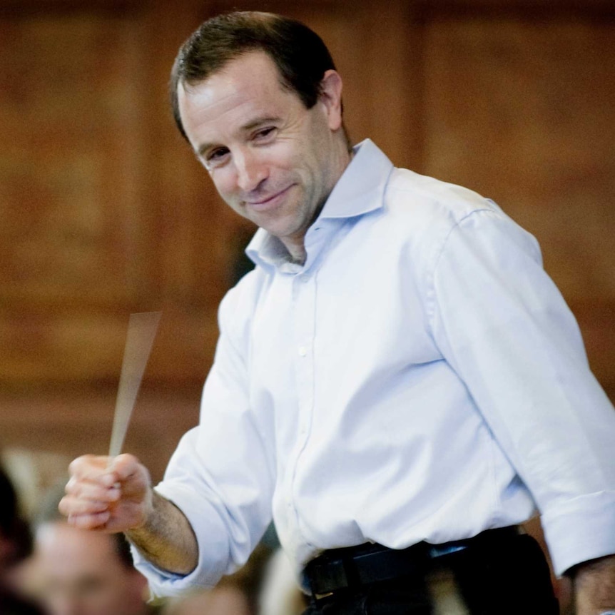 man smiling in shirt with baton in hand