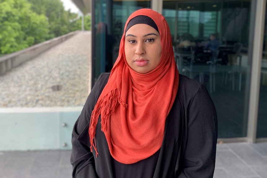 A muslim woman wearing a red head scarf