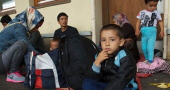 A young Afghan boy sits on a train platform