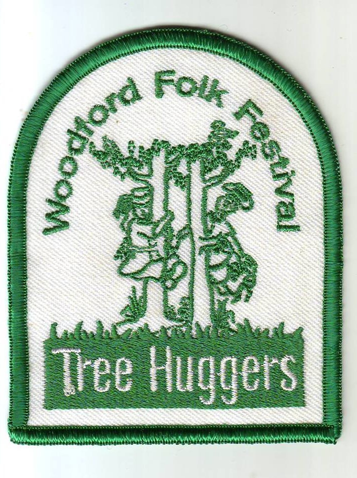 A fabric badge with the word treehugger and an image of people hugging trees embroidered on it.