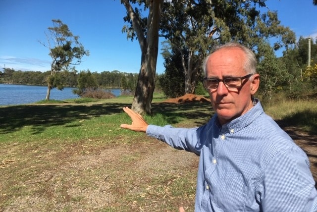 Independent State MP Greg Piper points to Macquarie Lake from the Myuna Bay Sports and Recreation Center