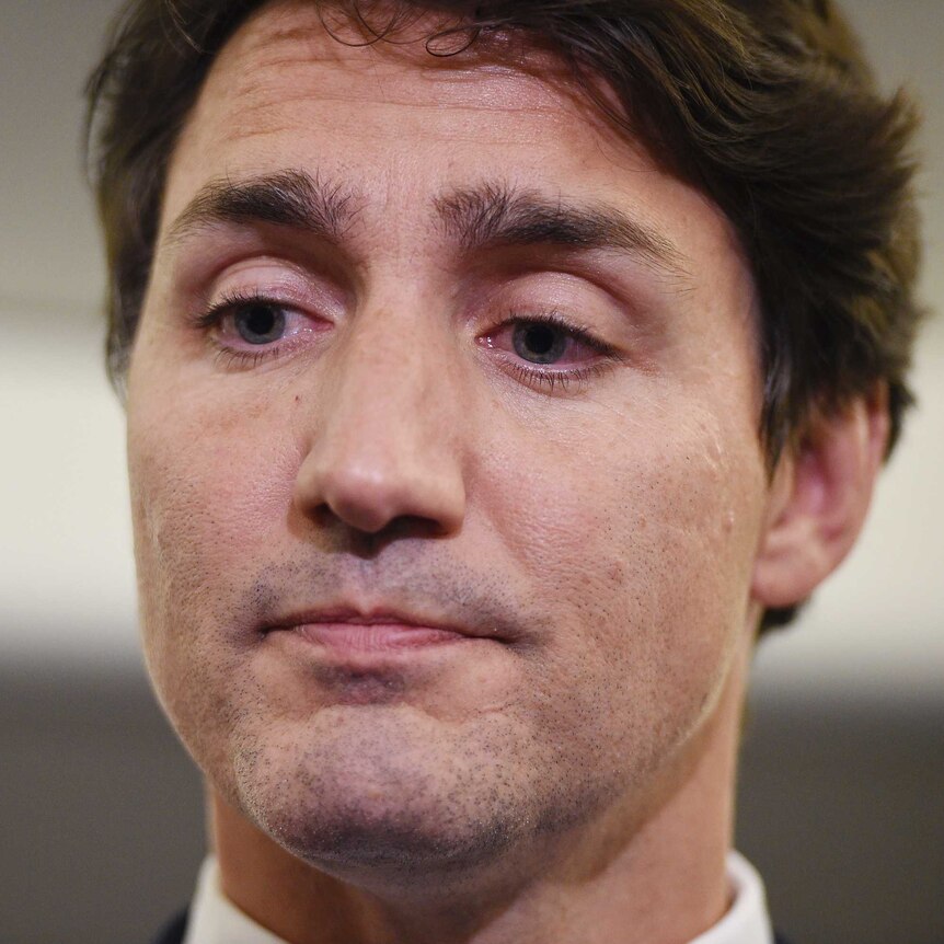 A close up of Justin Trudeau's face as he looks down