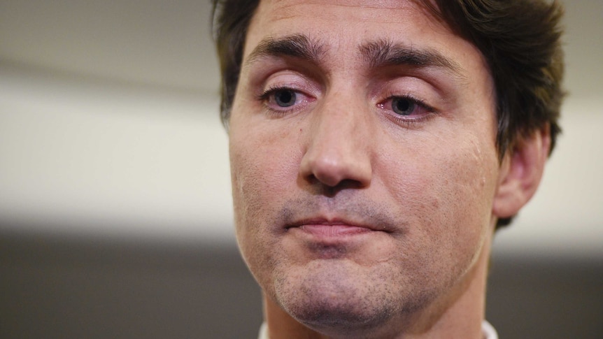 A close up of Justin Trudeau's face as he looks down