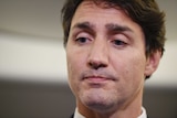 A close up of Justin Trudeau's face as he looks down