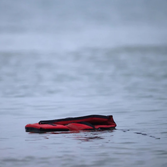 An empty life vest floats in the water