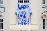 A hand-painted sign that reads where there is love there is hope