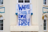 A hand-painted sign that reads where there is love there is hope