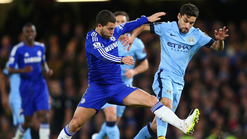 Eden Hazard of Chelsea tackles Jesus Navas of Manchester City