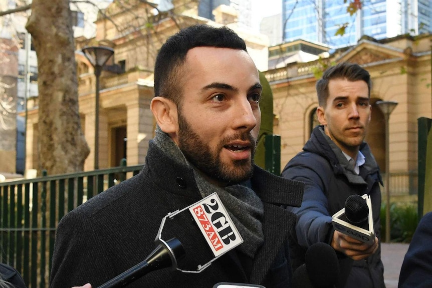 A man speaks to reporters outside court