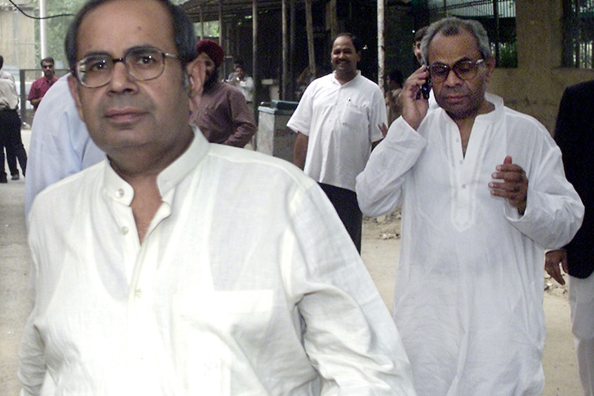Two men in traditional Indian white kurtas.