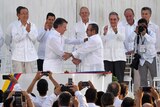 Colombian President Juan Manuel Santos shakes hands with head of the FARC guerrilla Timoleon Jimenez, aka Timochenko.